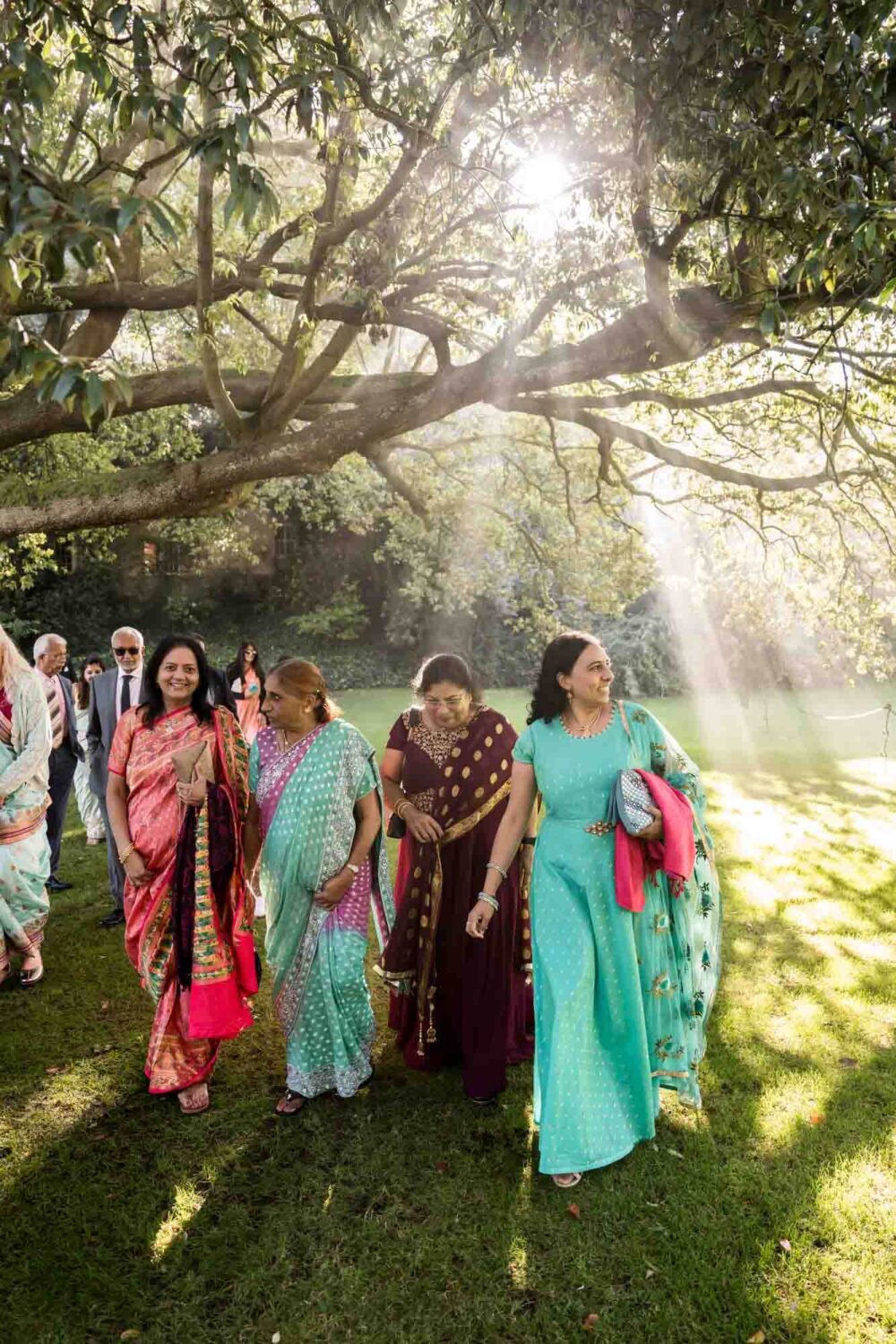 smokey shadows with guests walking through gardens at firle place