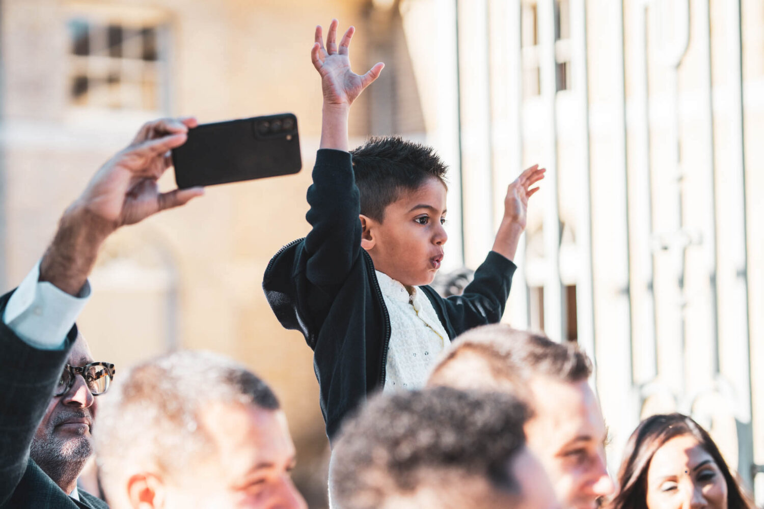 girl on dads shoulders at baraat at firle place