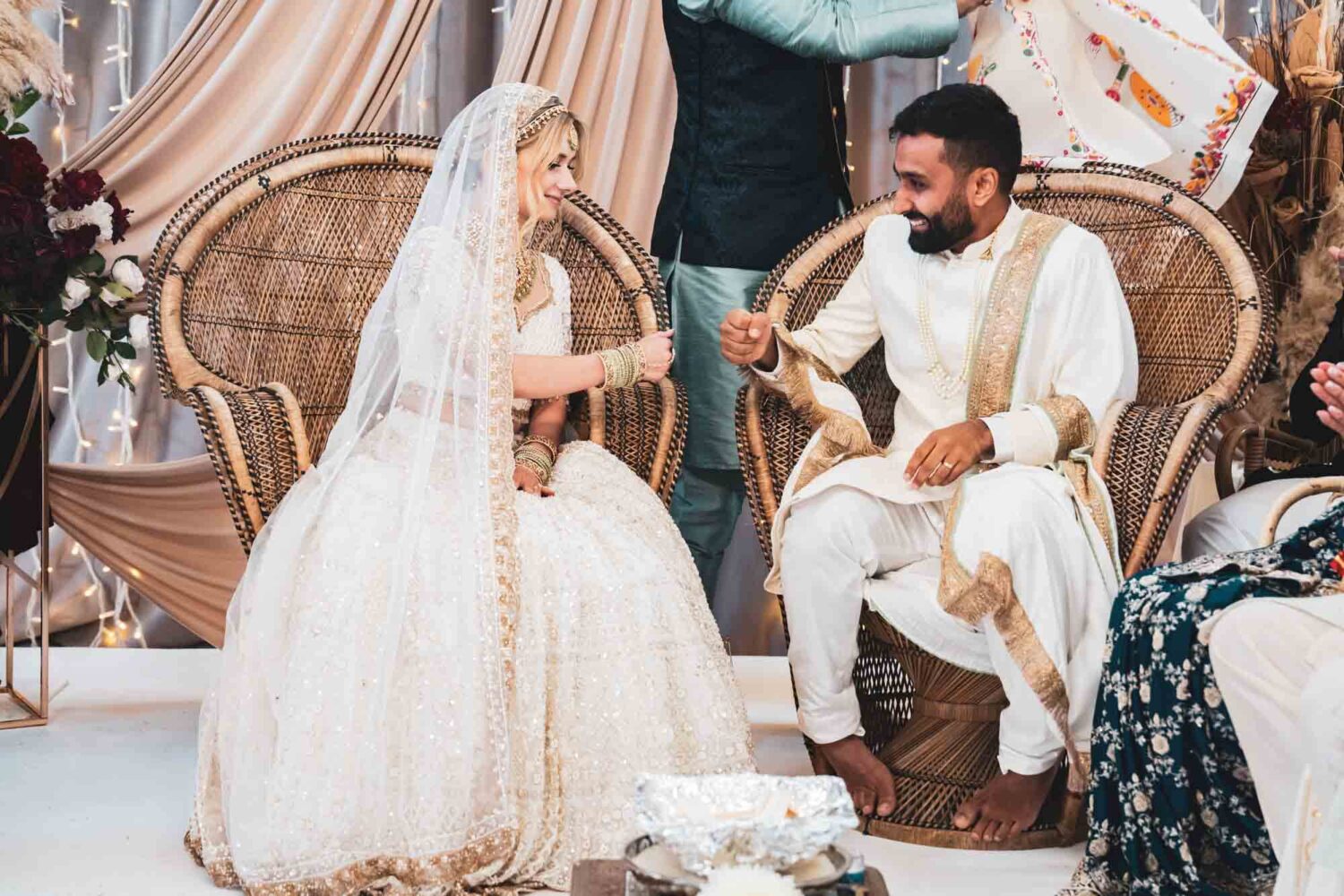 bride and groom punching fists at hindu ceremony at firle place