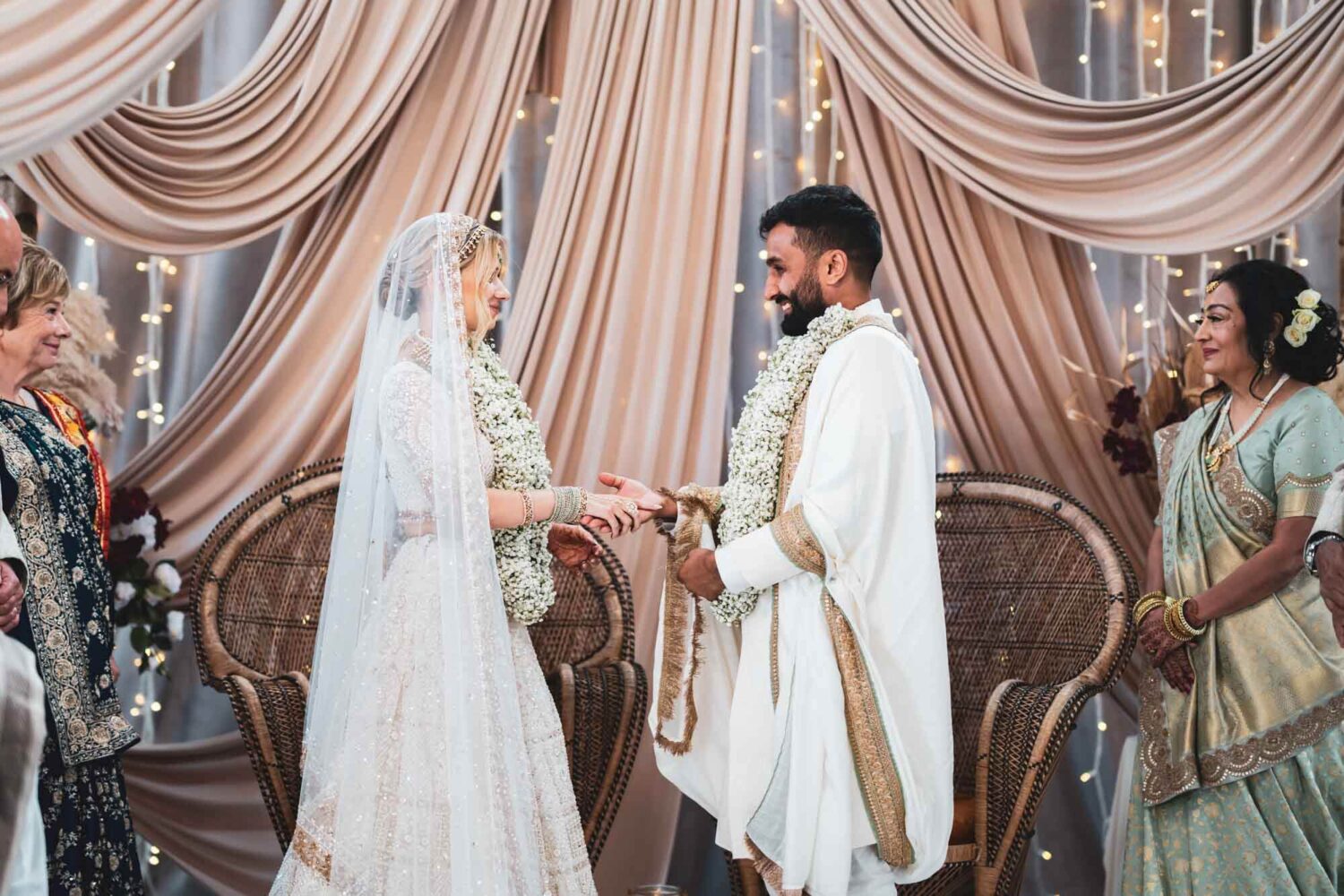 groom and bride on mandap at firle place holding hands