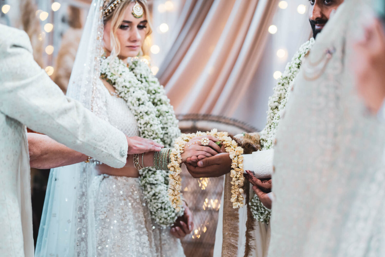 groom and bride on mandap at firle place holding hands