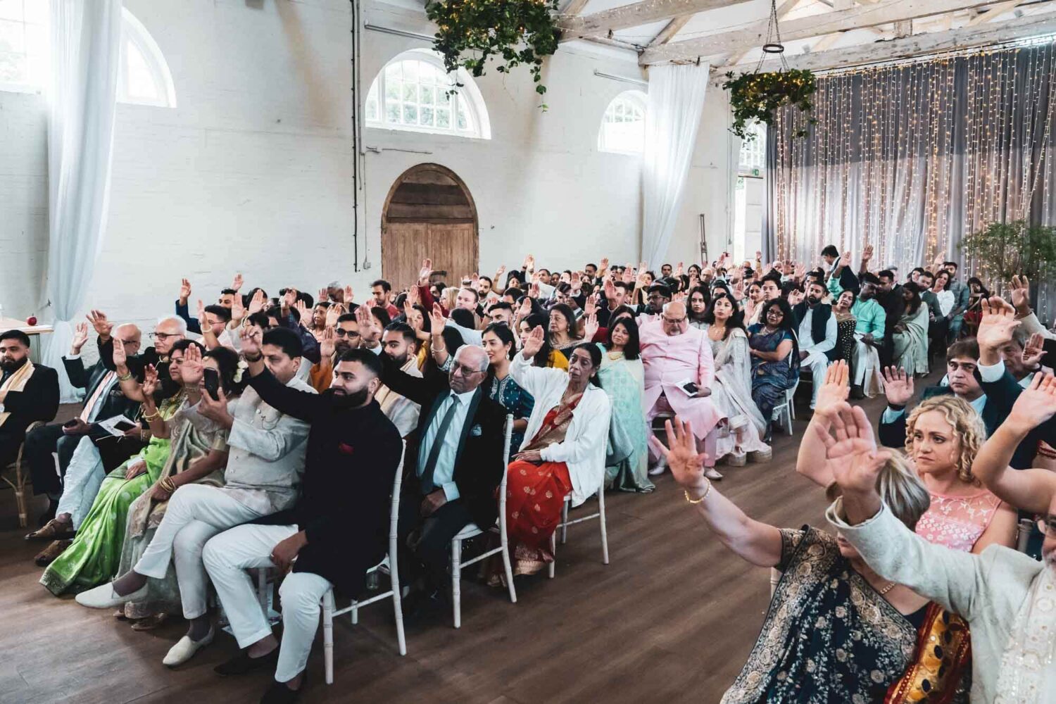 guests holding up hands at riding school at firle place