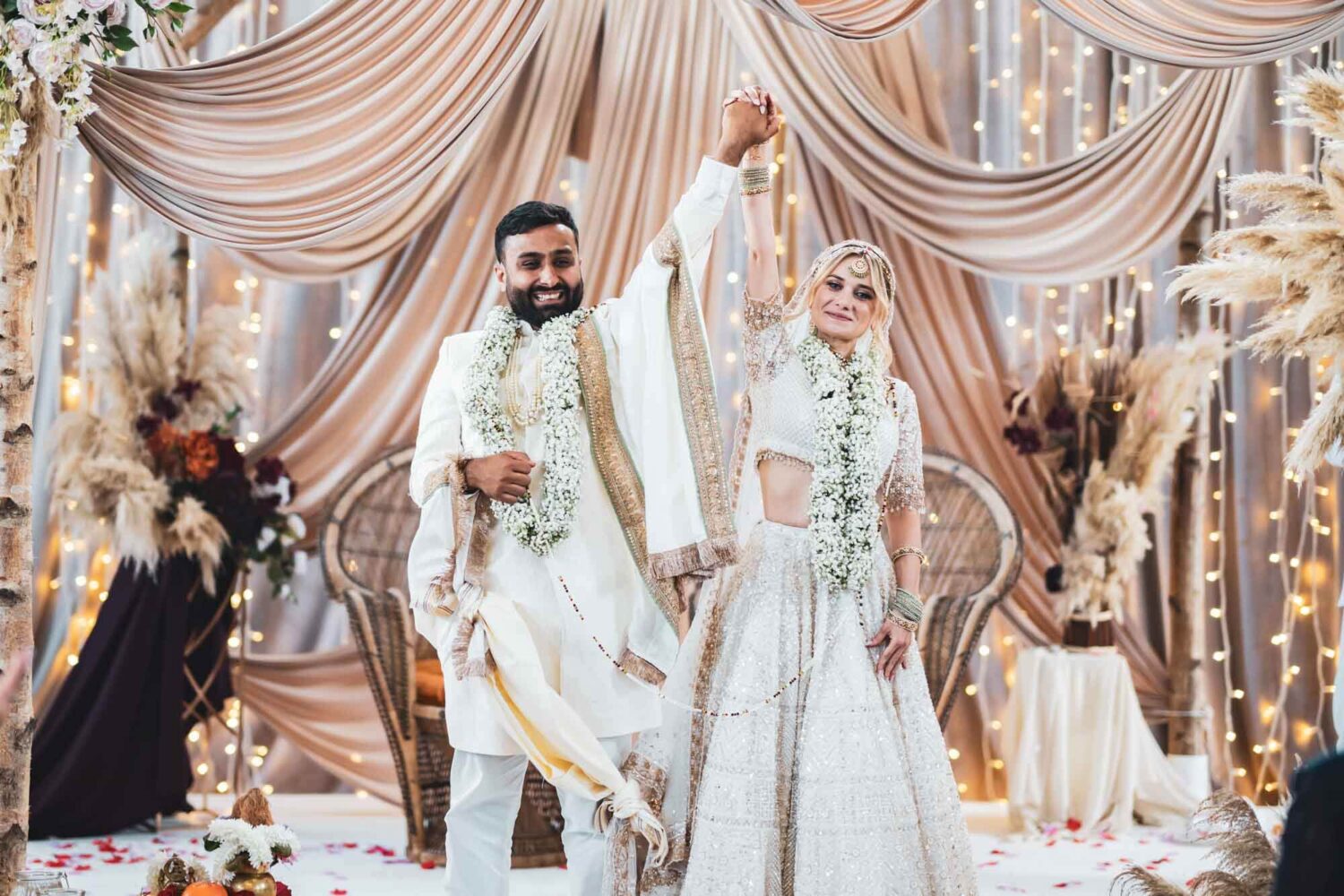 bride and groom on mandap at firle place celebrating getting married