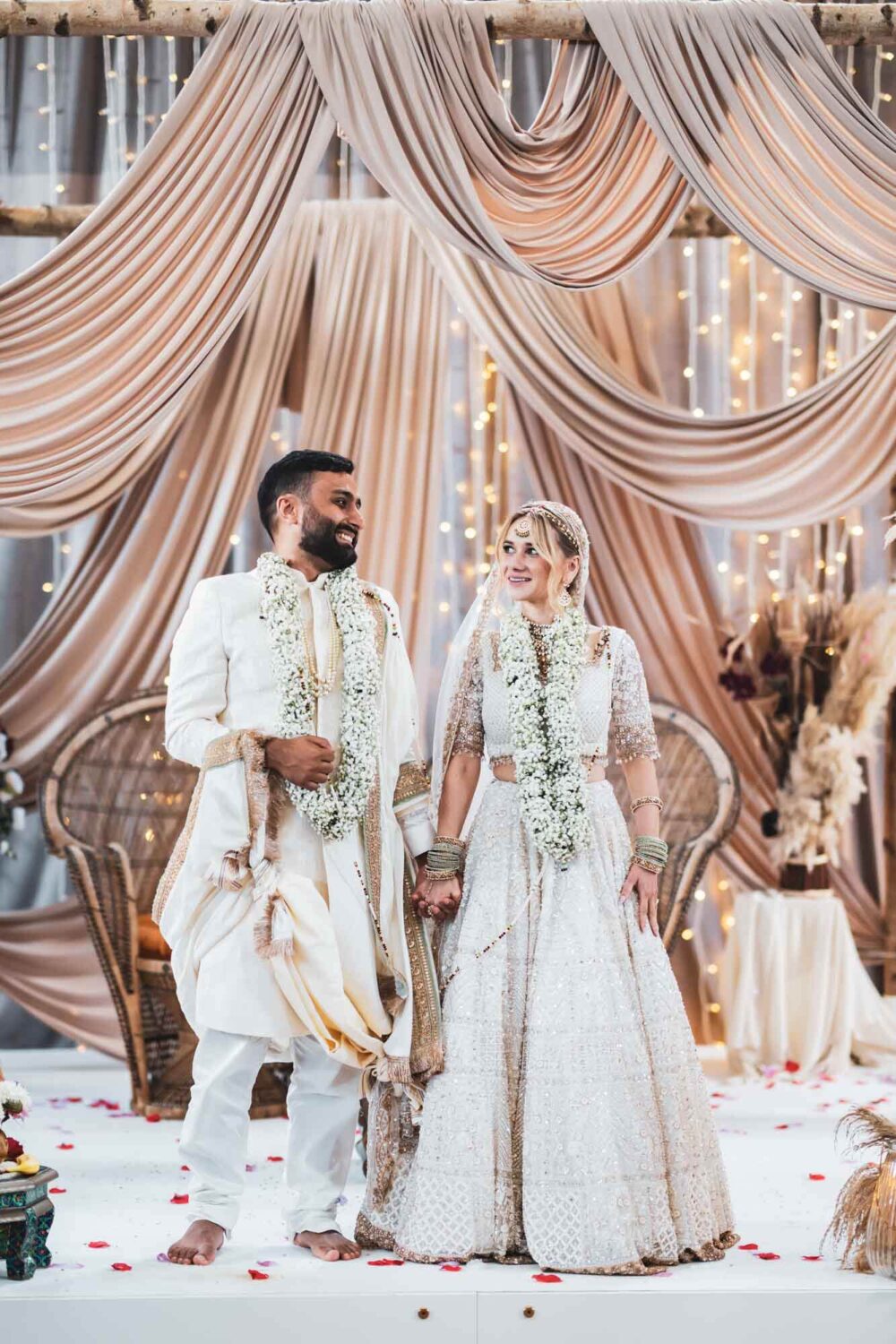 bride and groom on mandap at firle place celebrating getting married