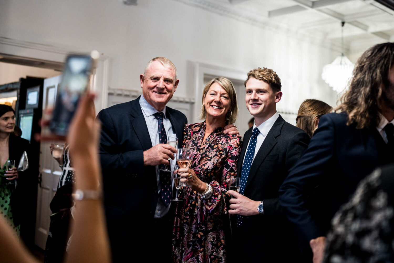guests having photo taken by a mobile during reception at highley manor