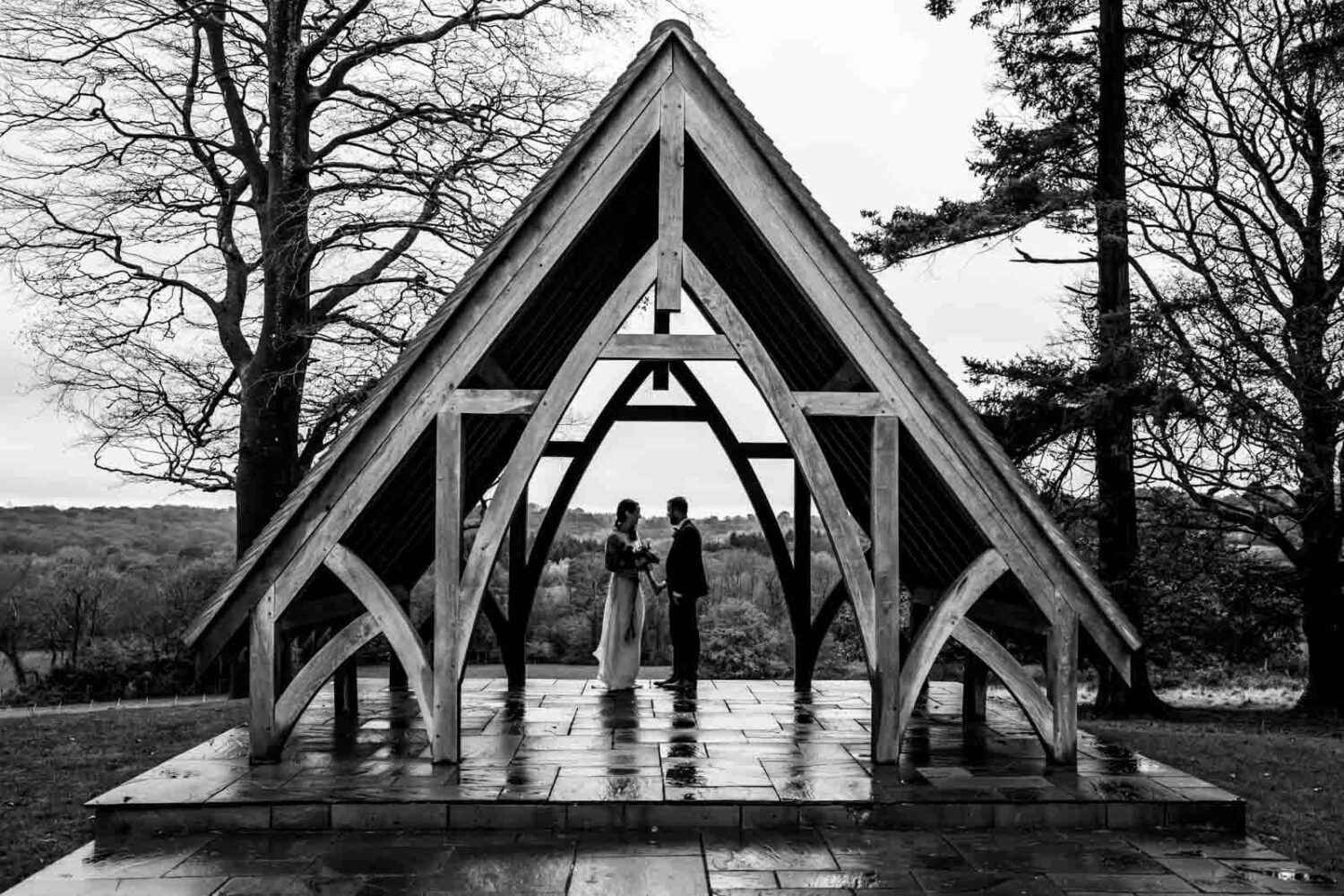 couple standing under wooden pavilion at highley manor