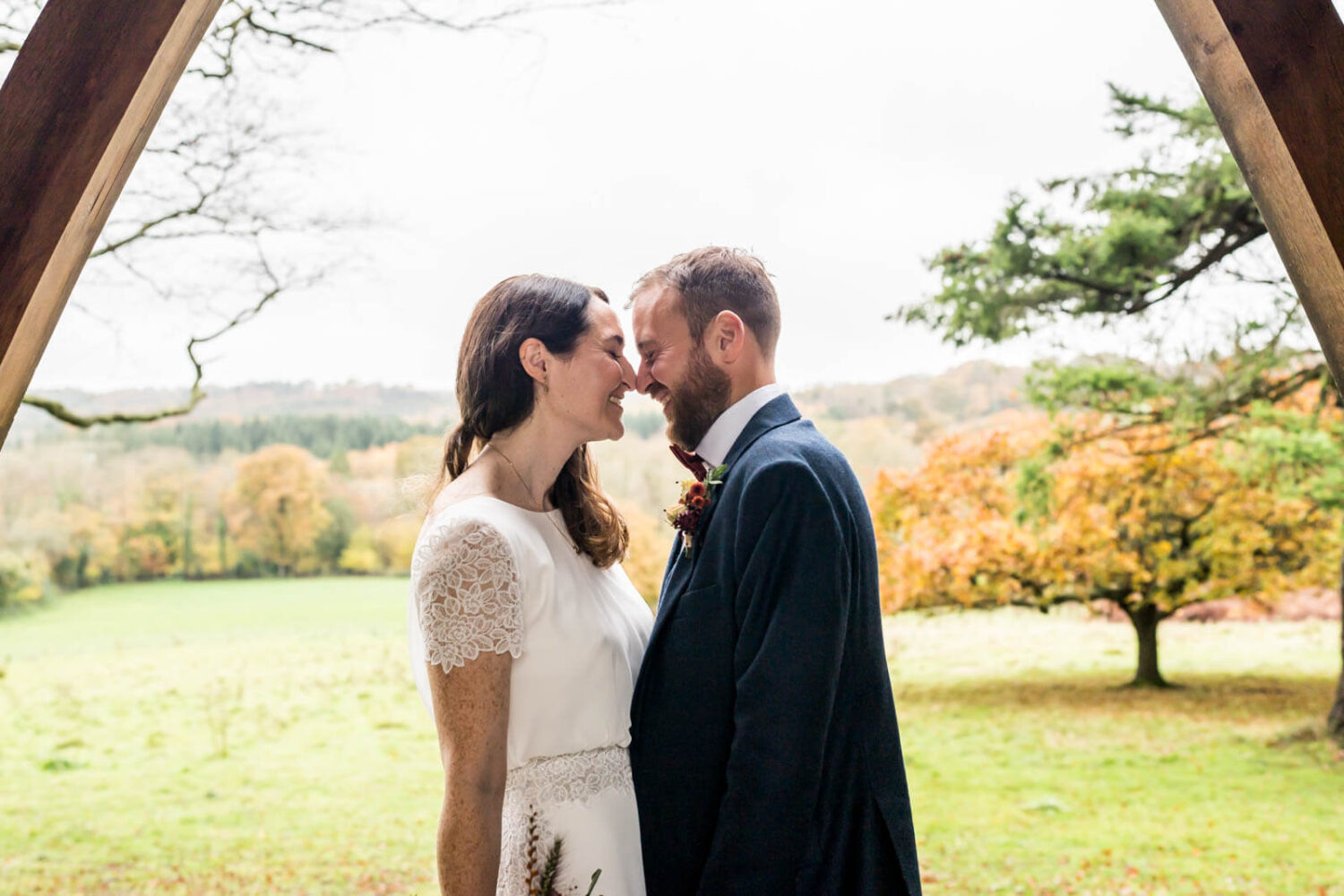 couple kissing with backdrop of sussex countryside at highley manor behind them