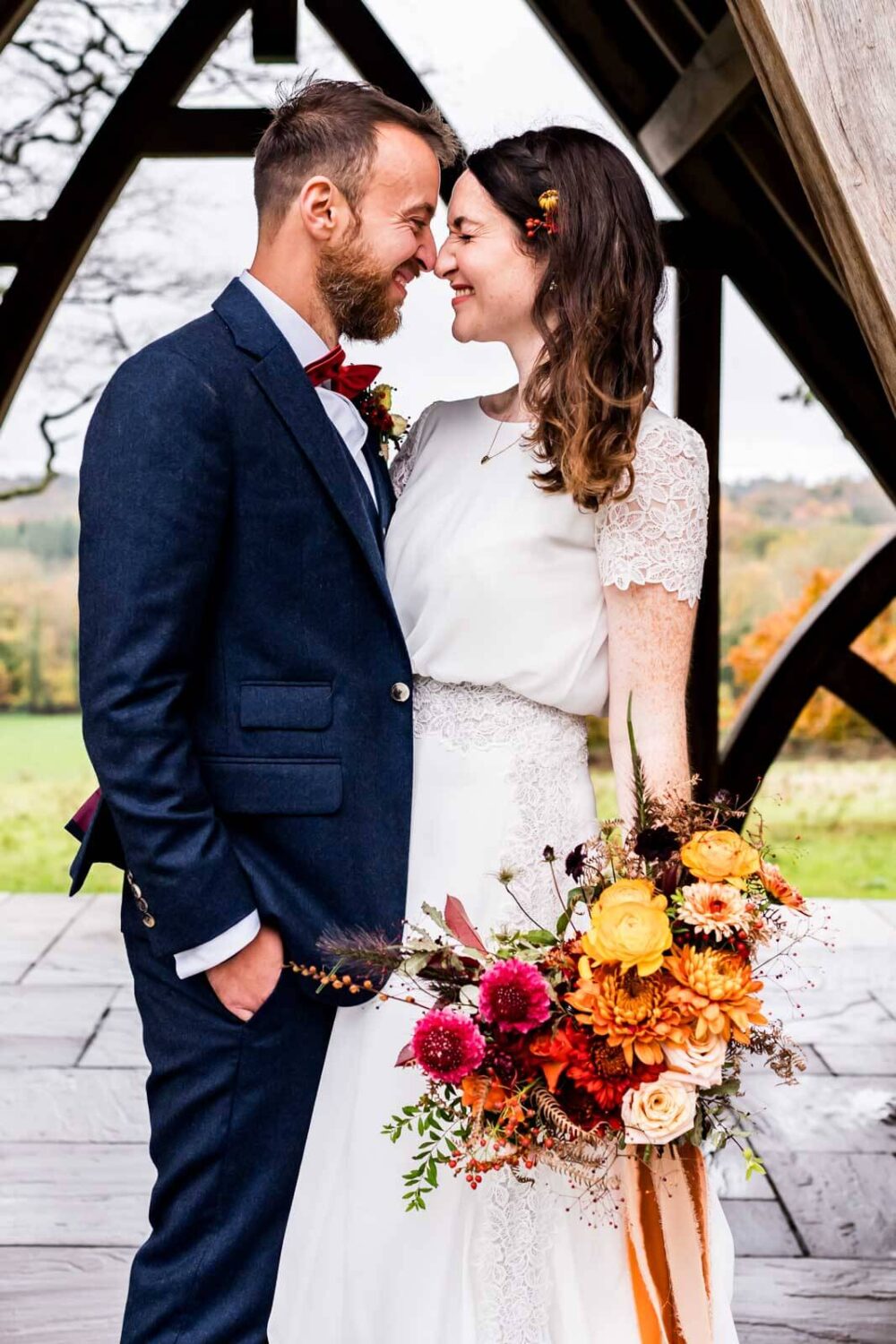 couple kissing with backdrop of sussex countryside at highley manor behind them