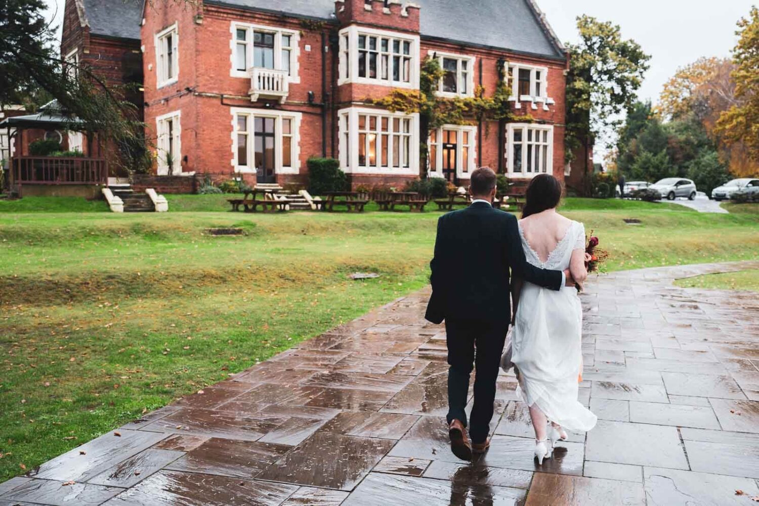 couple walking towards highley manor house arm in arm