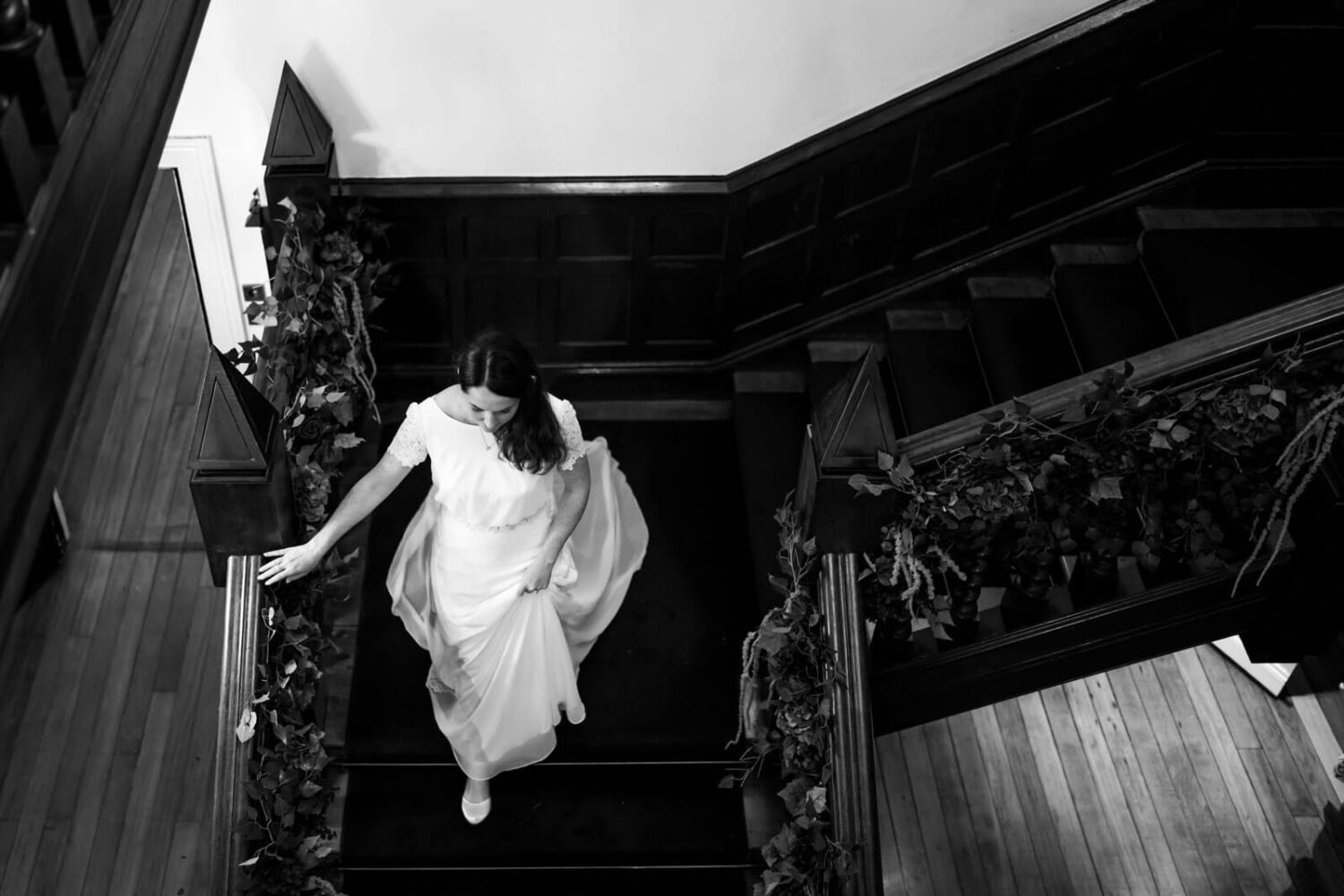 above shot of bride walking down staircase at highley manor