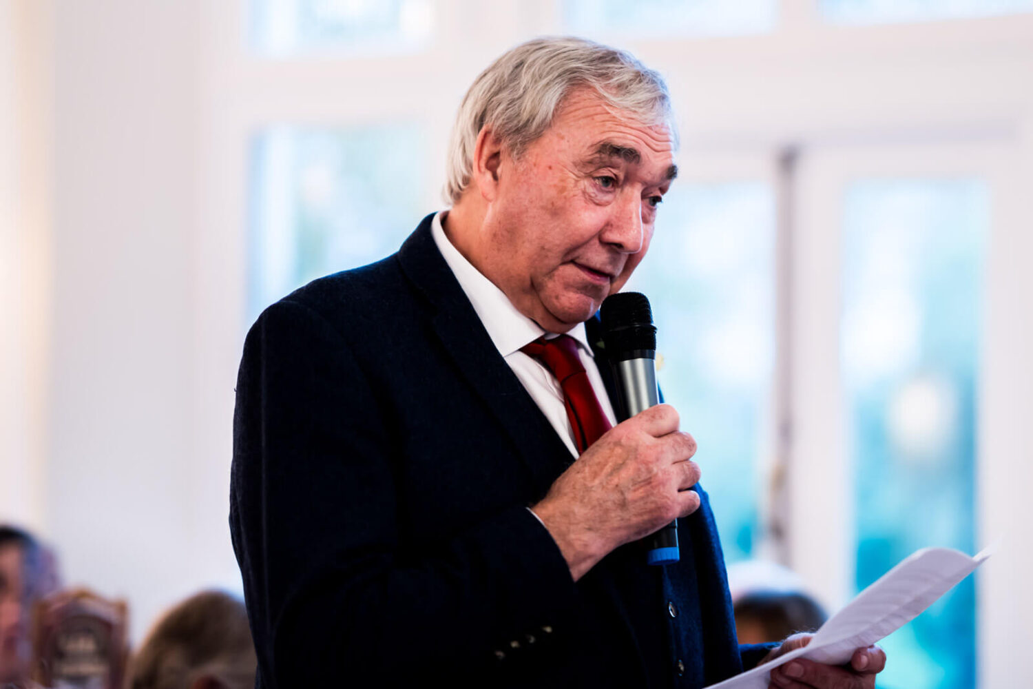father holding microphone doing speech