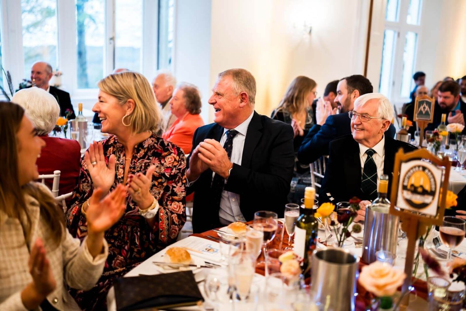 guests laughing and clapping during speeches