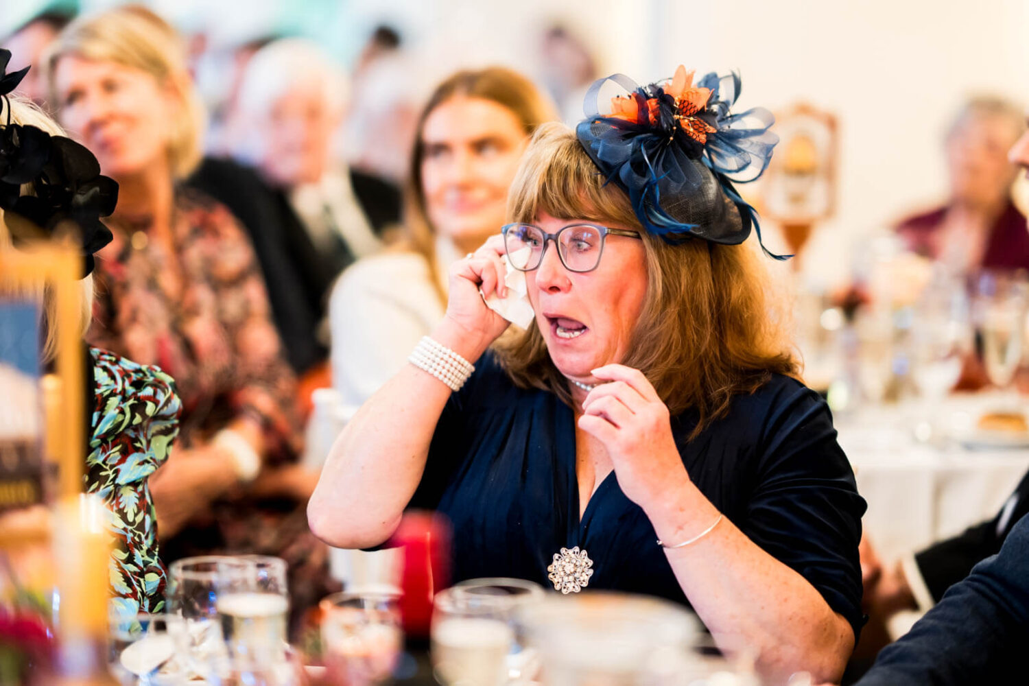 mother of groom wiping away tears during speeches