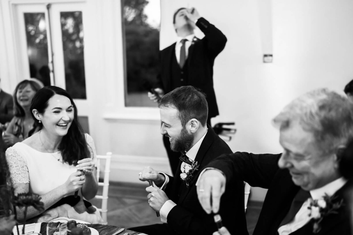 brother of groom necking a shot of vodka during speech