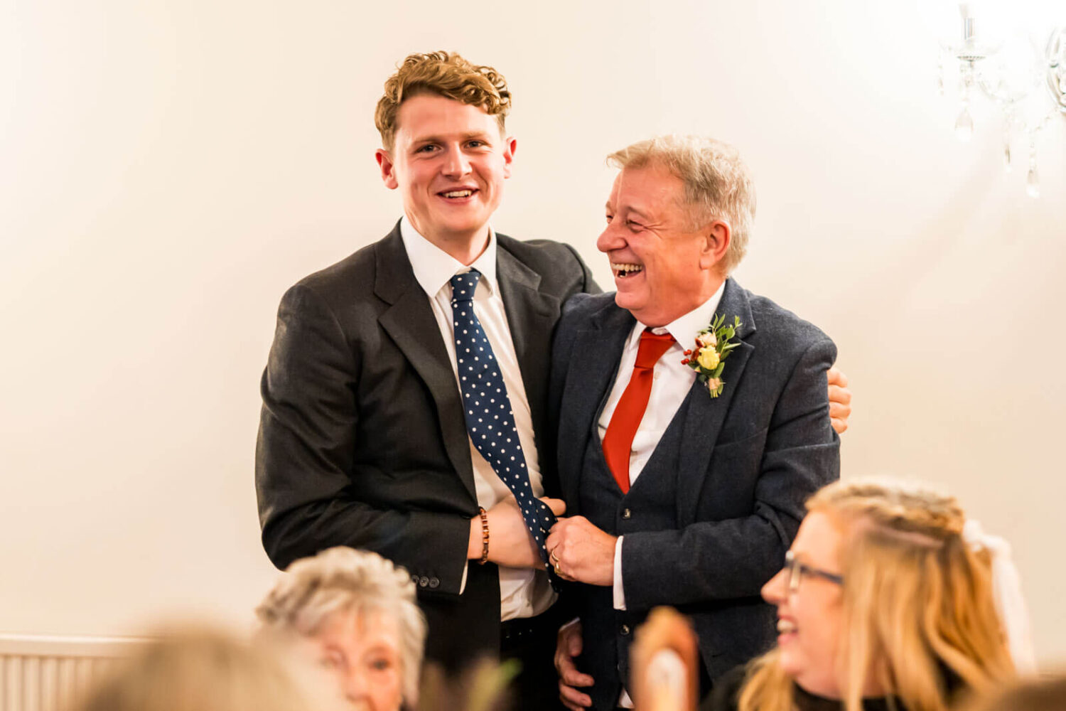 two guests hugging during speeches