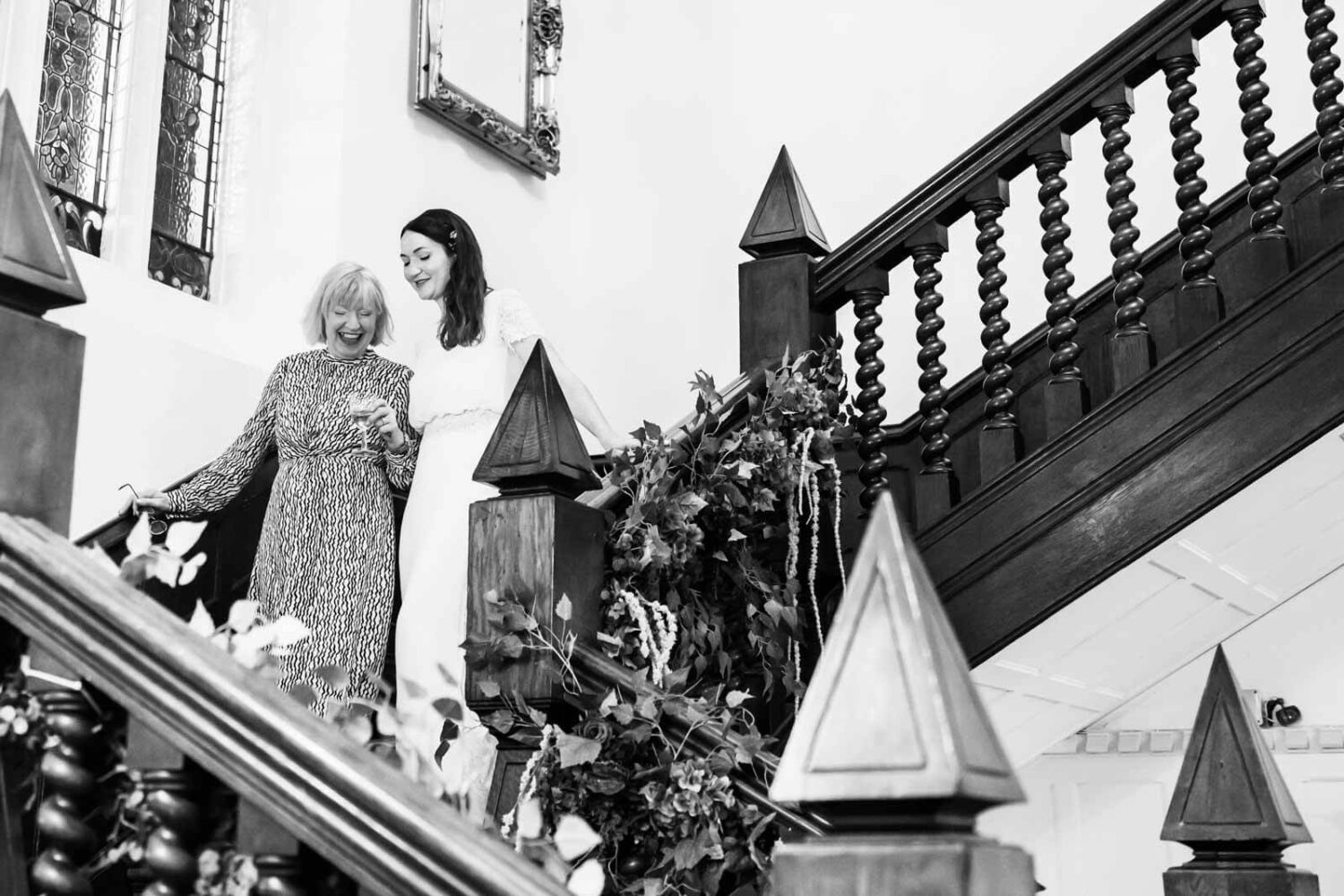 mother and daughter walking down staircase at highley manor