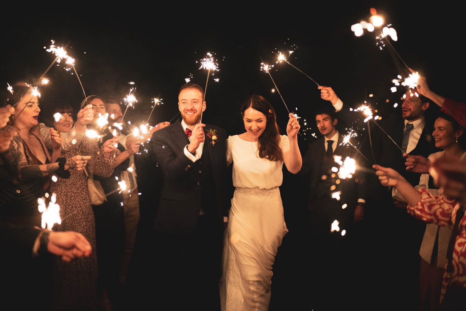couple walking with sparklers at highley manor