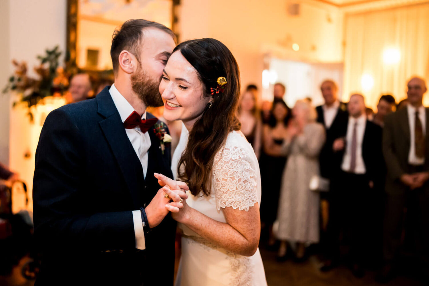 groom whispering to bride as they do first dance