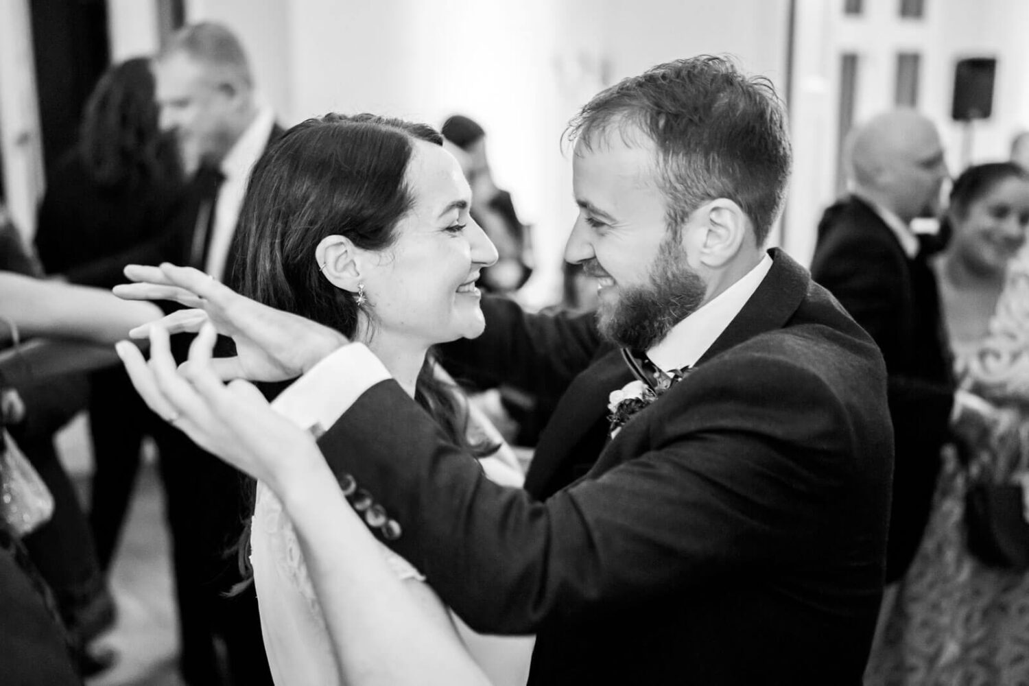 bride and groom holding hands while doing first dance