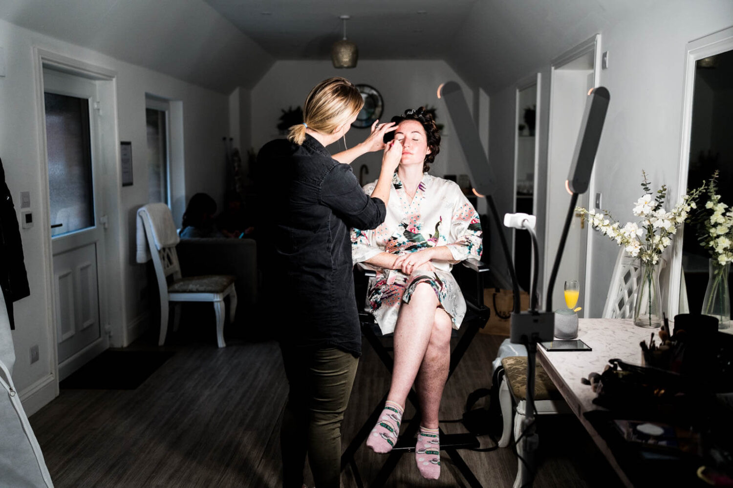 bride having eye make up put on in dressing room at highley manor