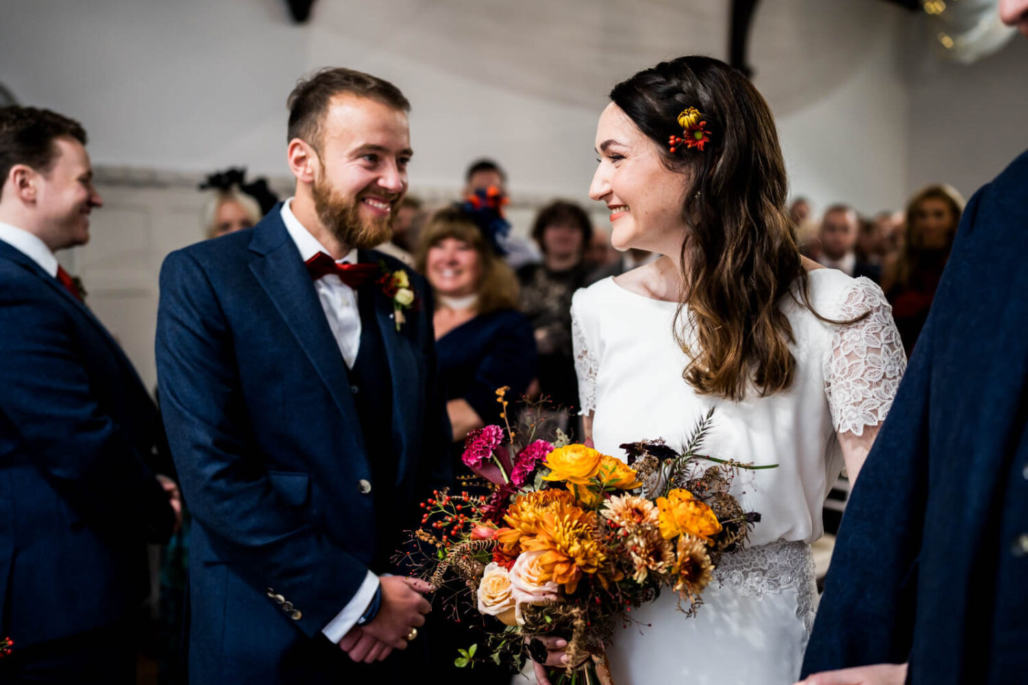 groom looking and smiling at bride for the first time at highley manor