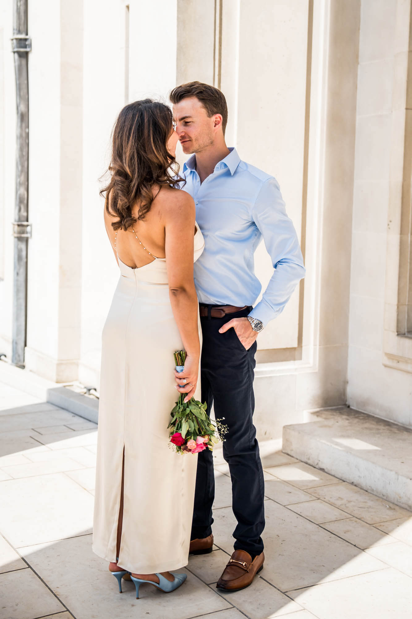 bride back to camera groom hand in pocket up close to his wife london wedding