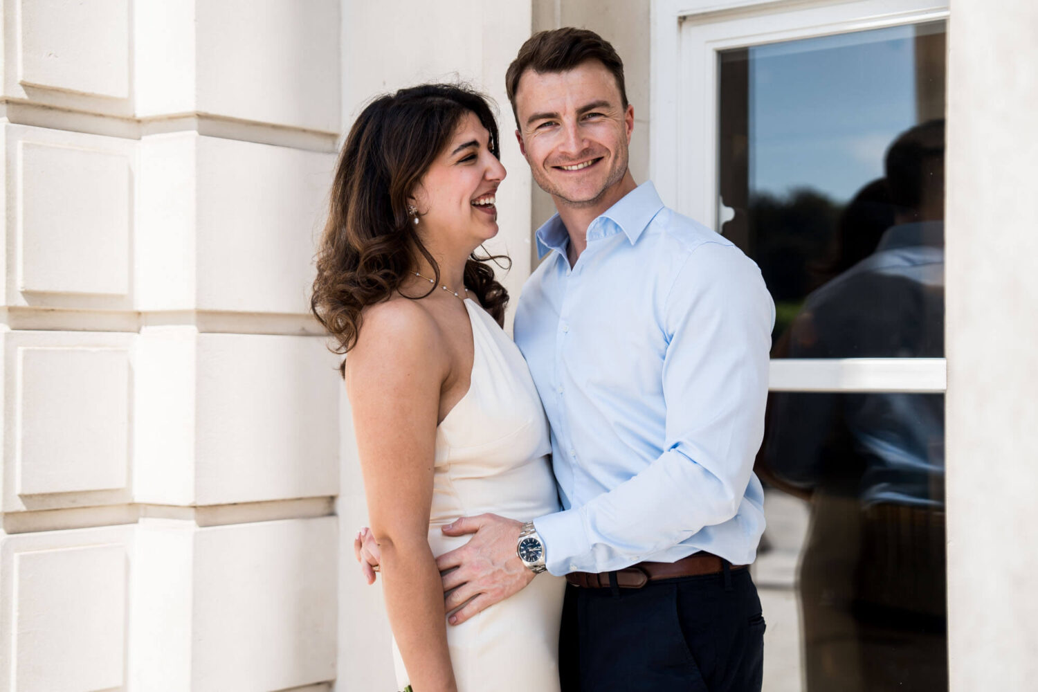 bride side to camera smiling at groom london wedding
