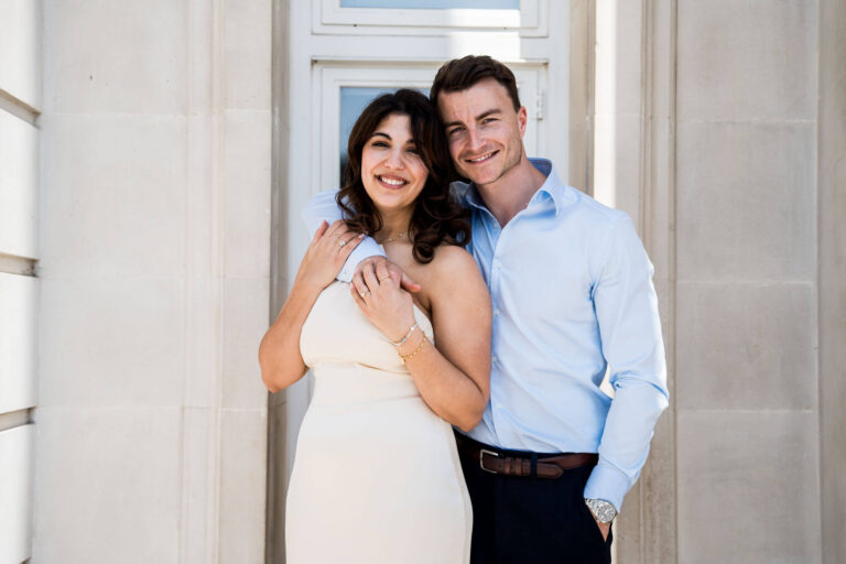 groom arms around bride her hands holding his london wedding