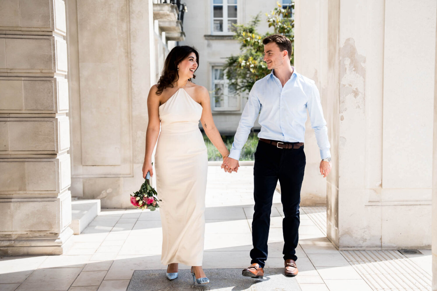 bride and groom walking hand in hand waltham forest town hall