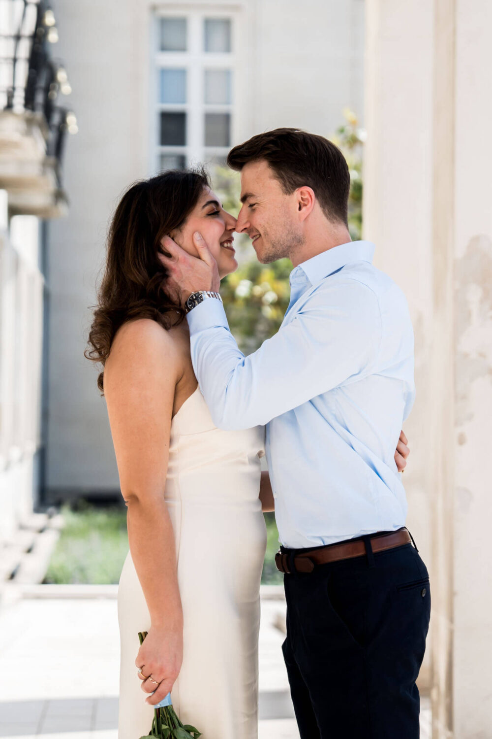 groom bringing bride in close for a kiss london wedding