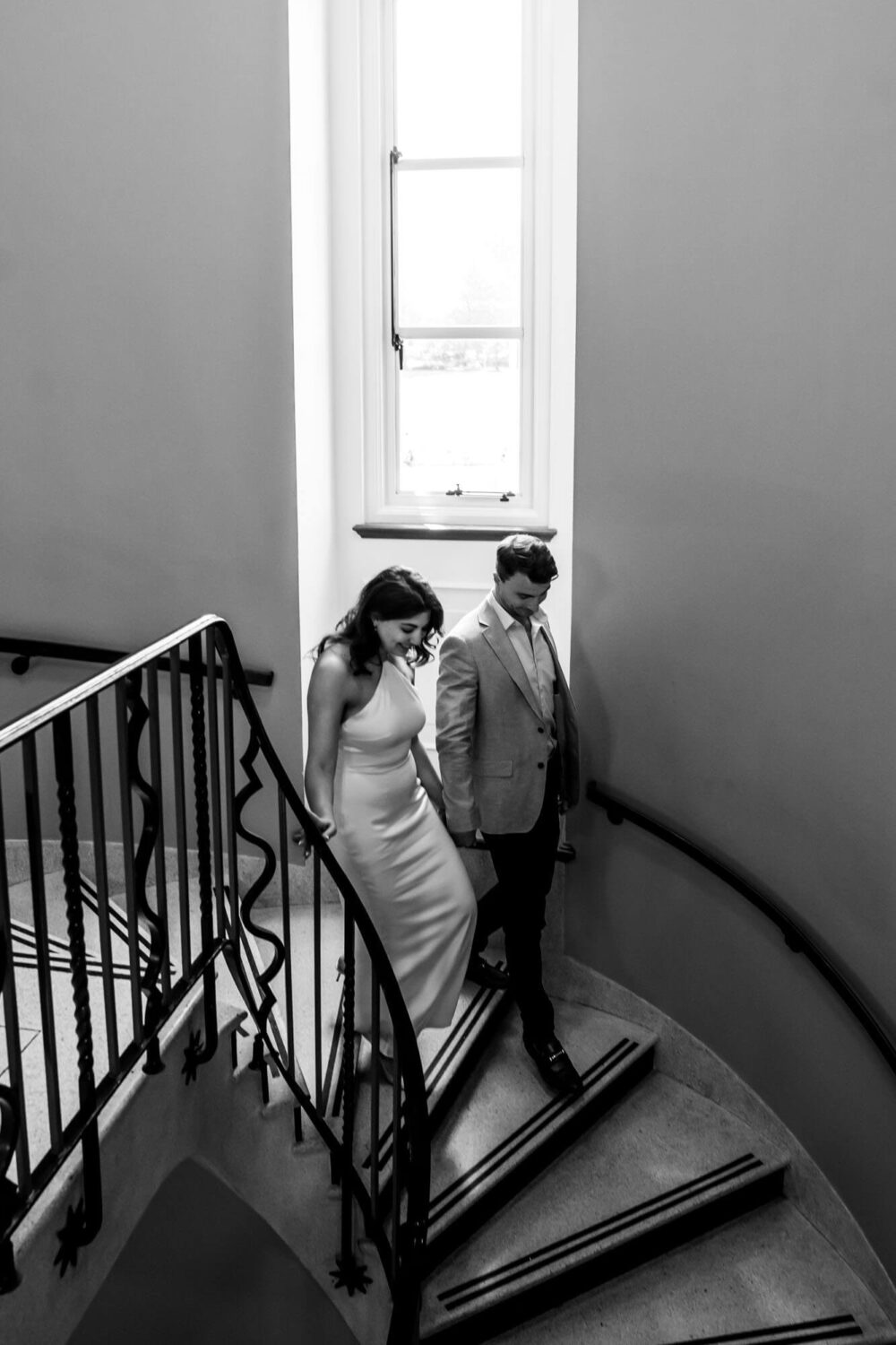 bride and groom walking down the stairs having just married london wedding