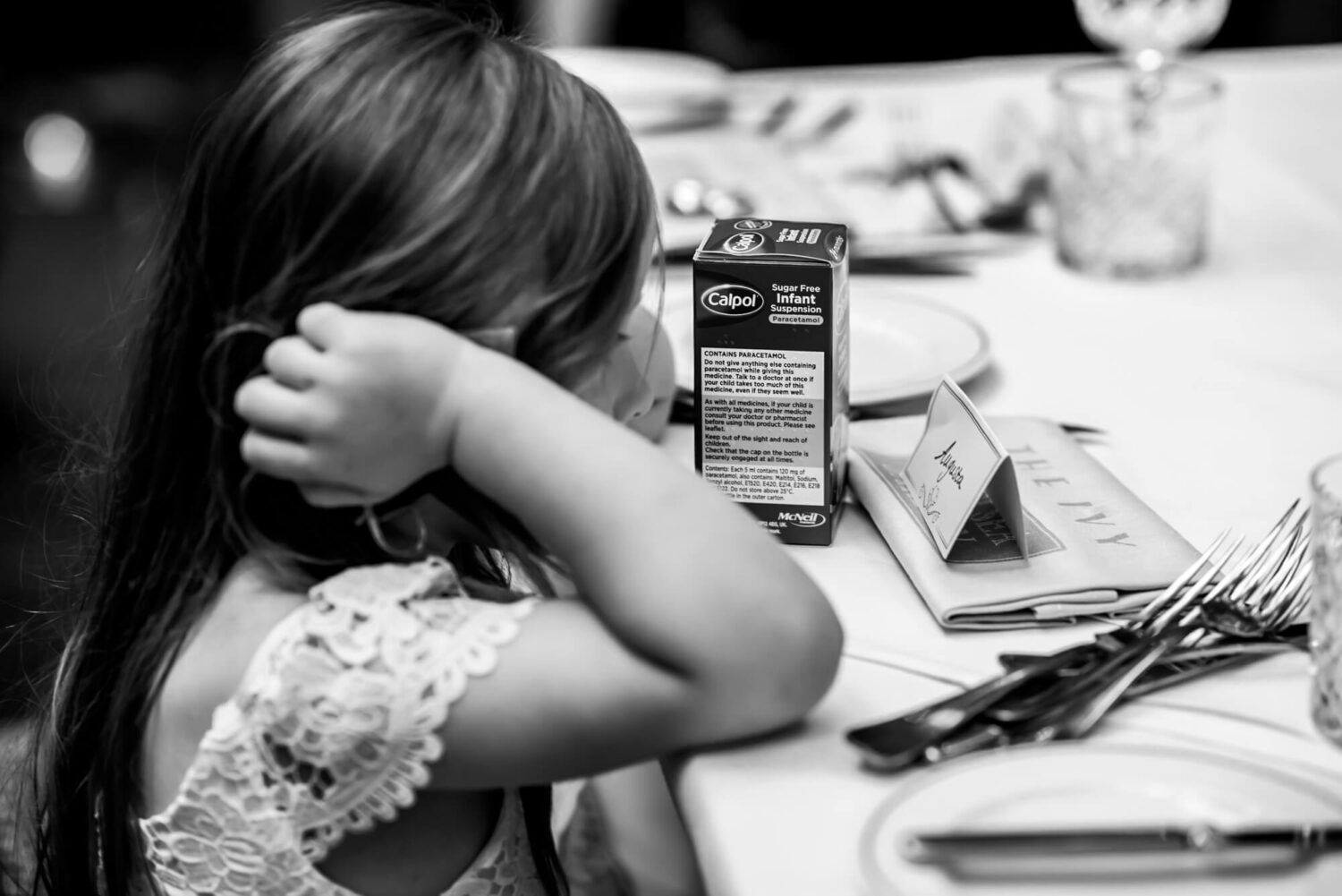 bridesmaid looking at bottle of calpol arms on table london wedding