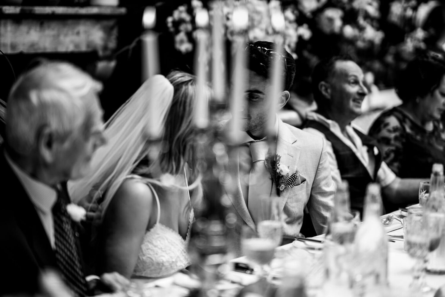 bride and groom behind blurred candle london wedding