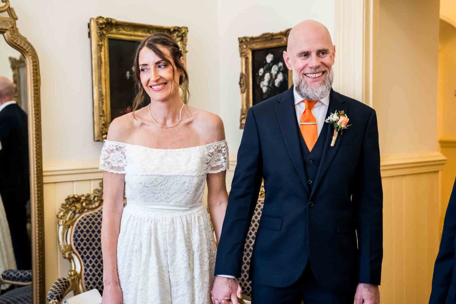 bride-and-groom-holding-hands-floral-room-brighton-wedding