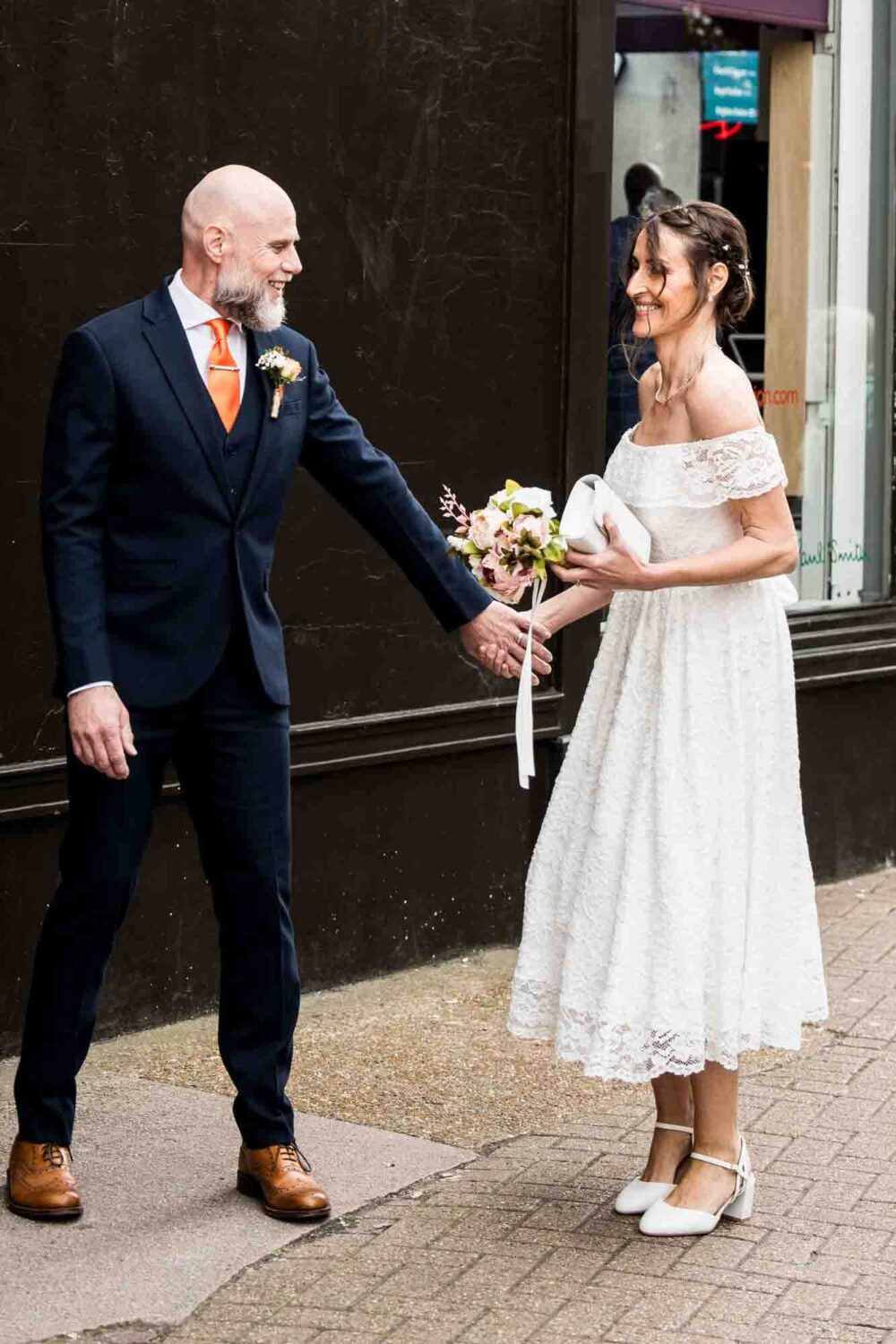 bride-and-groom-playful-on-streets-brighton-town-hall-wedding