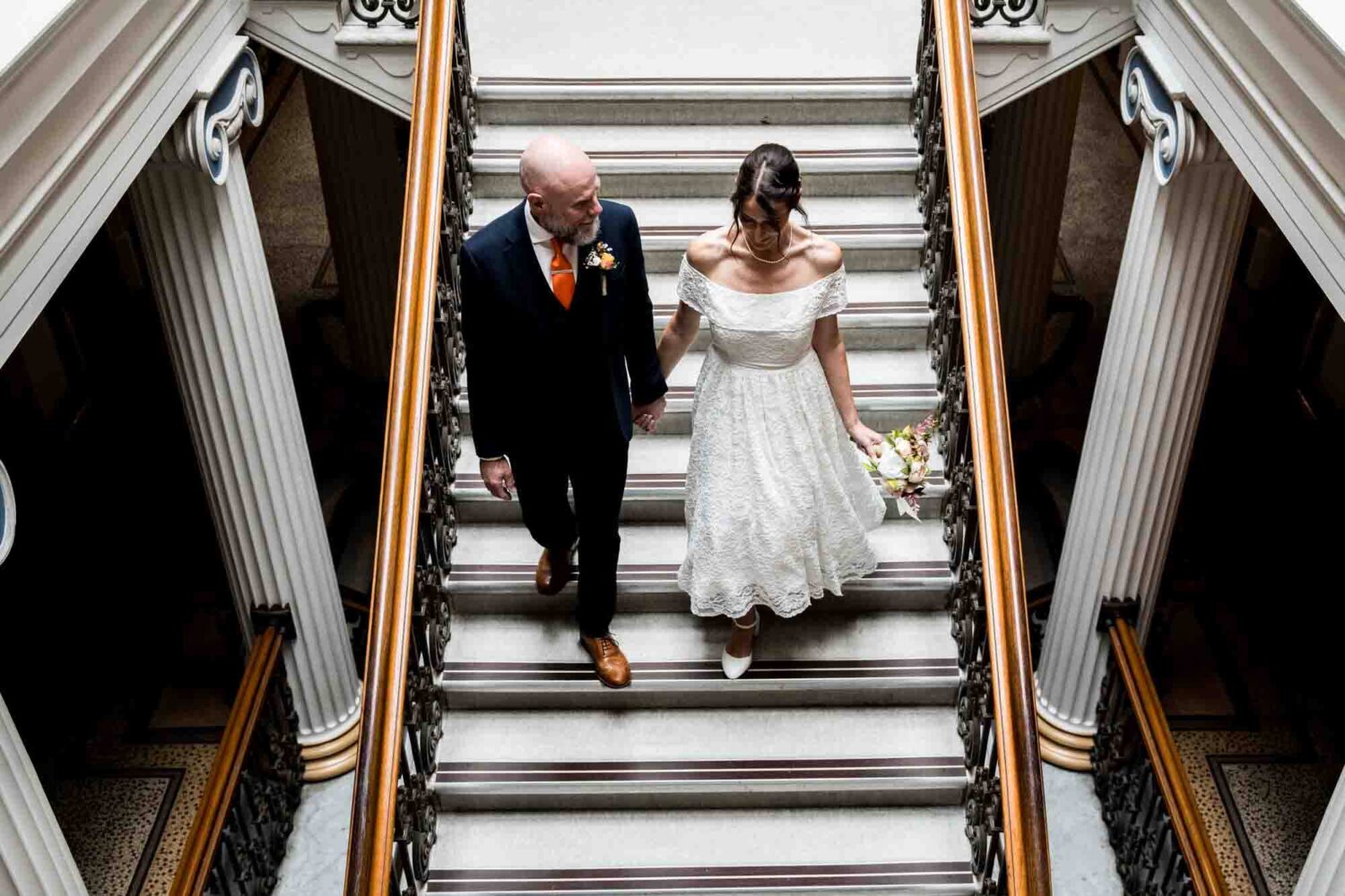 bride-groom-walking-down-stairs-brighton-town-hall-wedding
