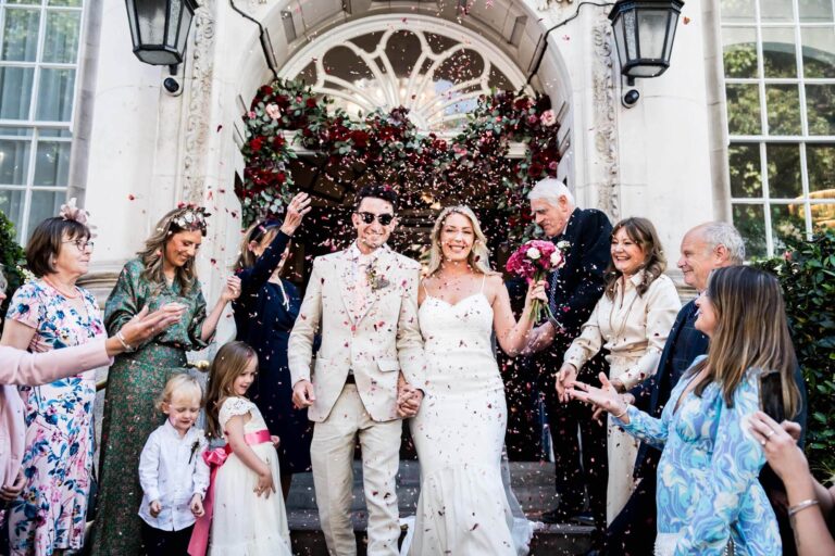 bride and groom walking through confetti chelsea town hall