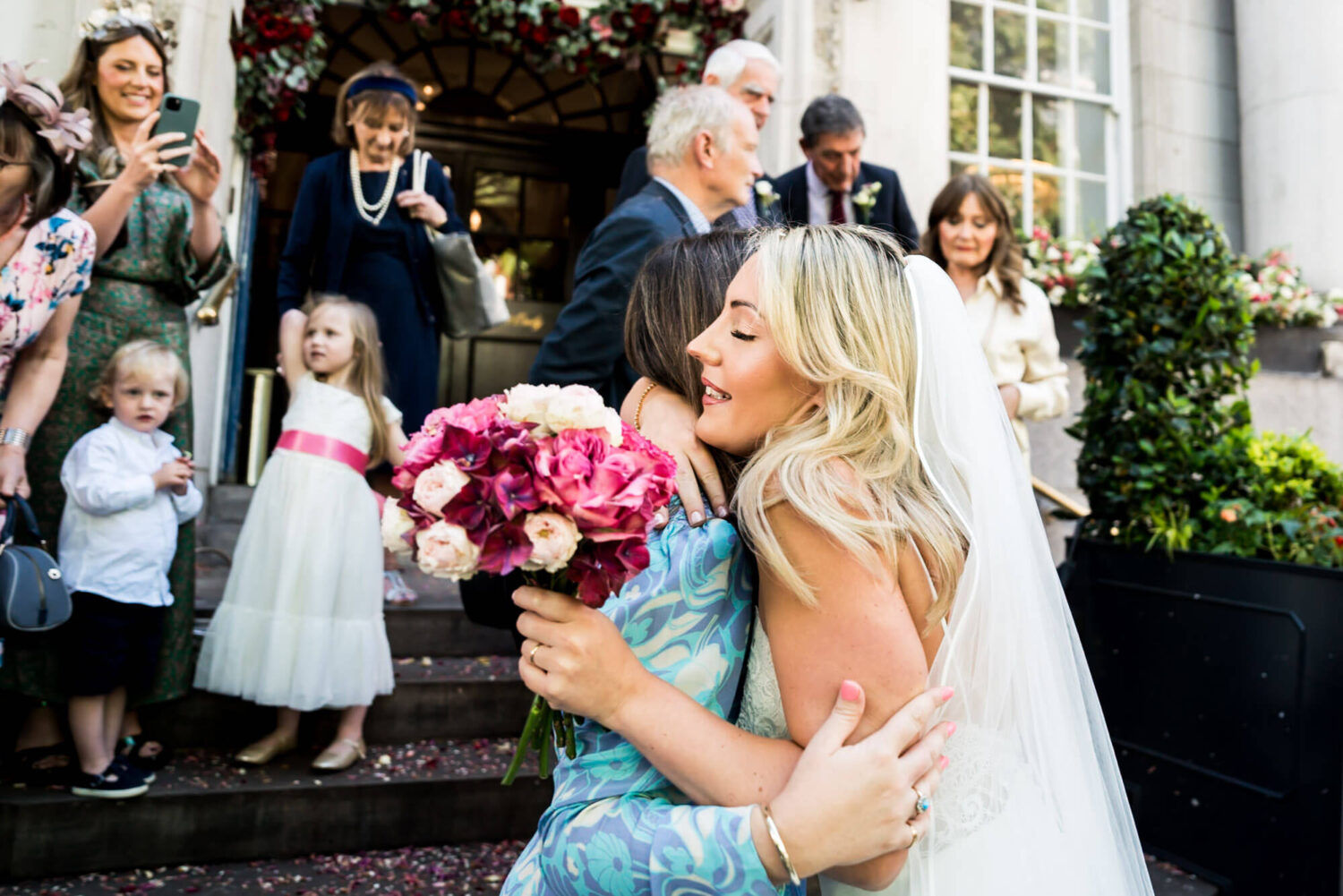 bride hugging friend london wedding
