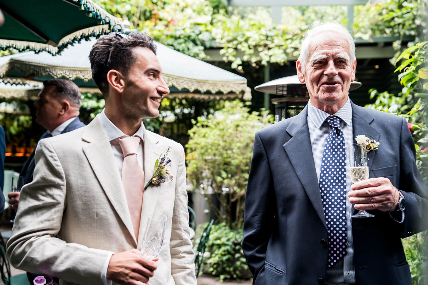 groom and father of bride sharing a joke london wedding