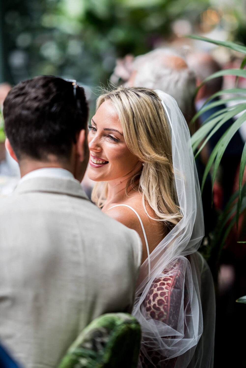 bride smiling at groom shot from behind london wedding