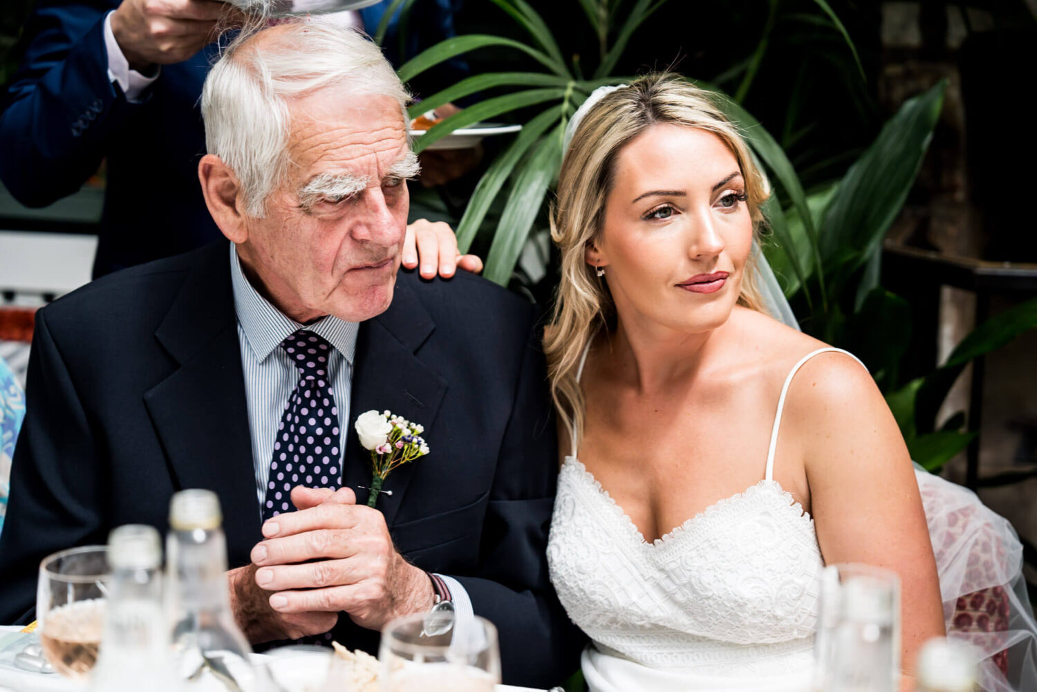 bride with hand on father's shoulder london wedding