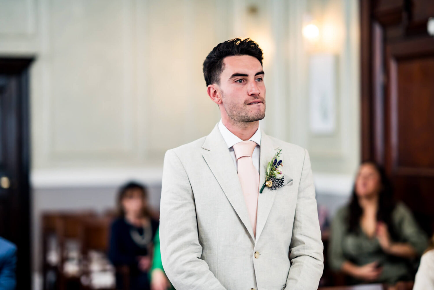 groom nervously biting his lip london wedding