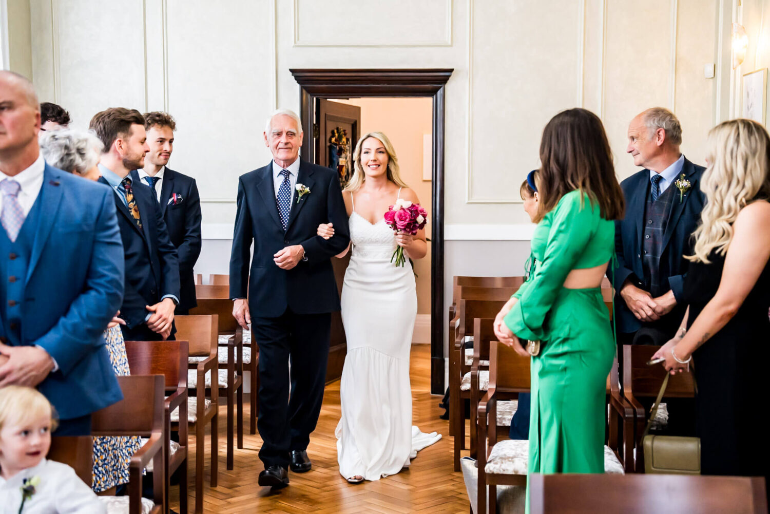 bride walking down aisle with her dad chelsea town hall