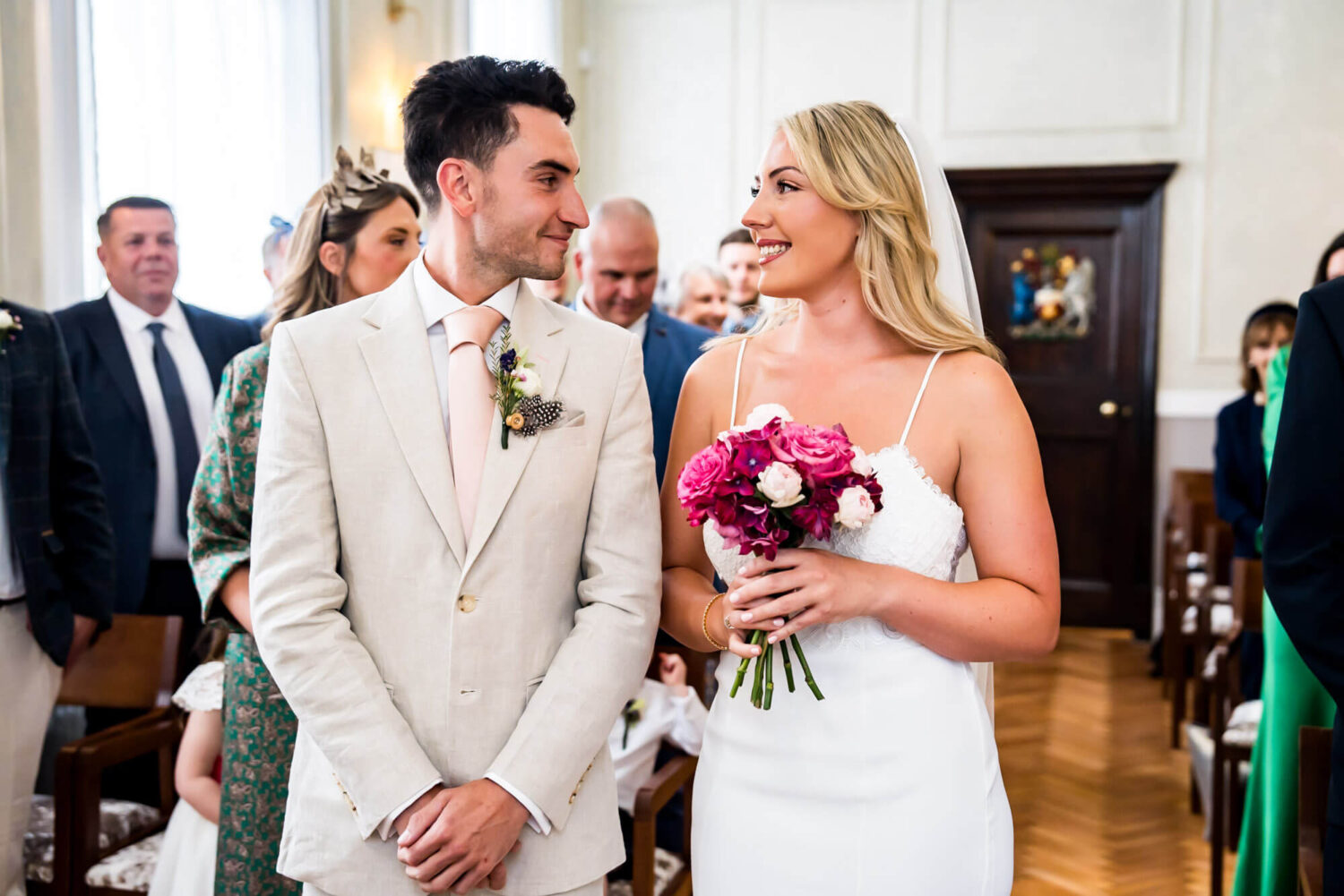 bride and groom smiling at each other chelsea town hall wedding