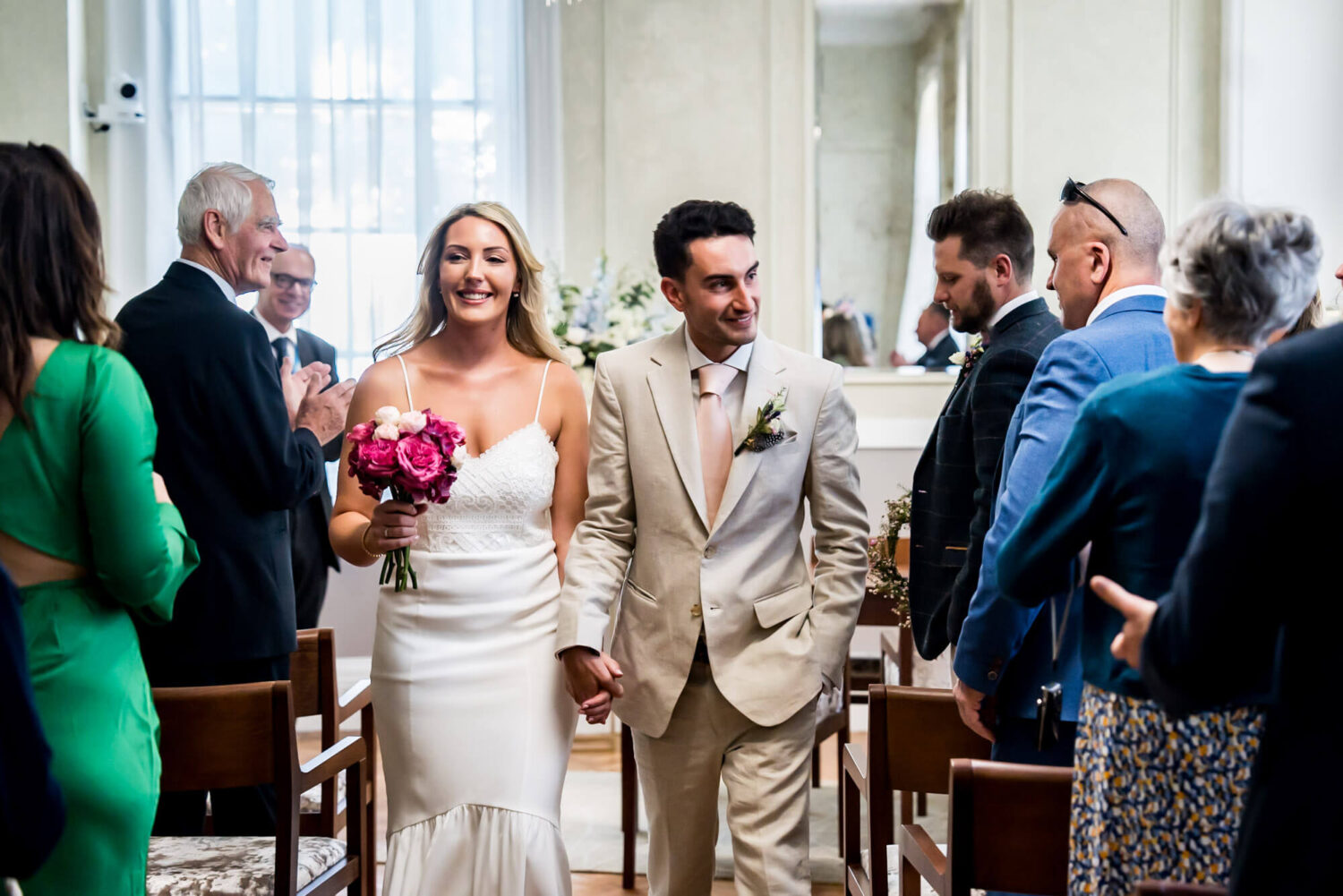 bride and groom walking back down aisle chelsea town hall