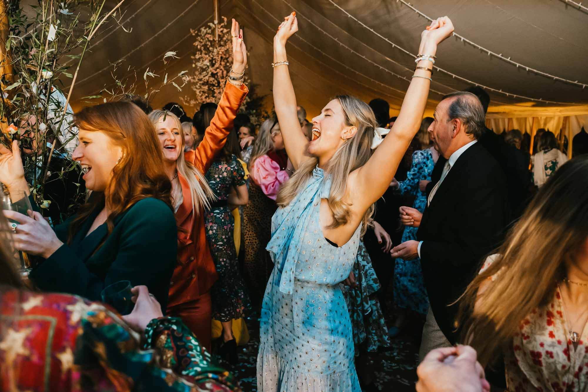 guest with hands in air dancing hampshire wedding