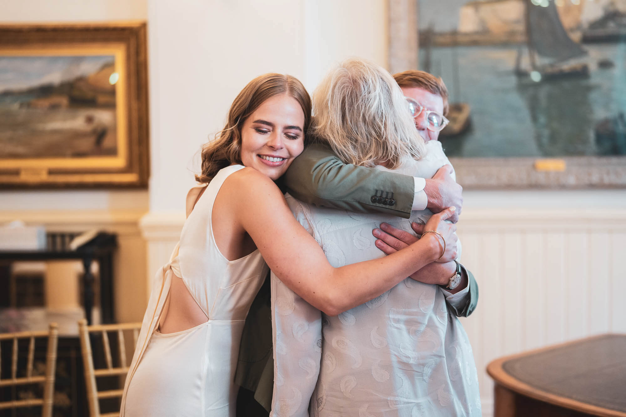 bride groom and mother all hugging brighton town hall