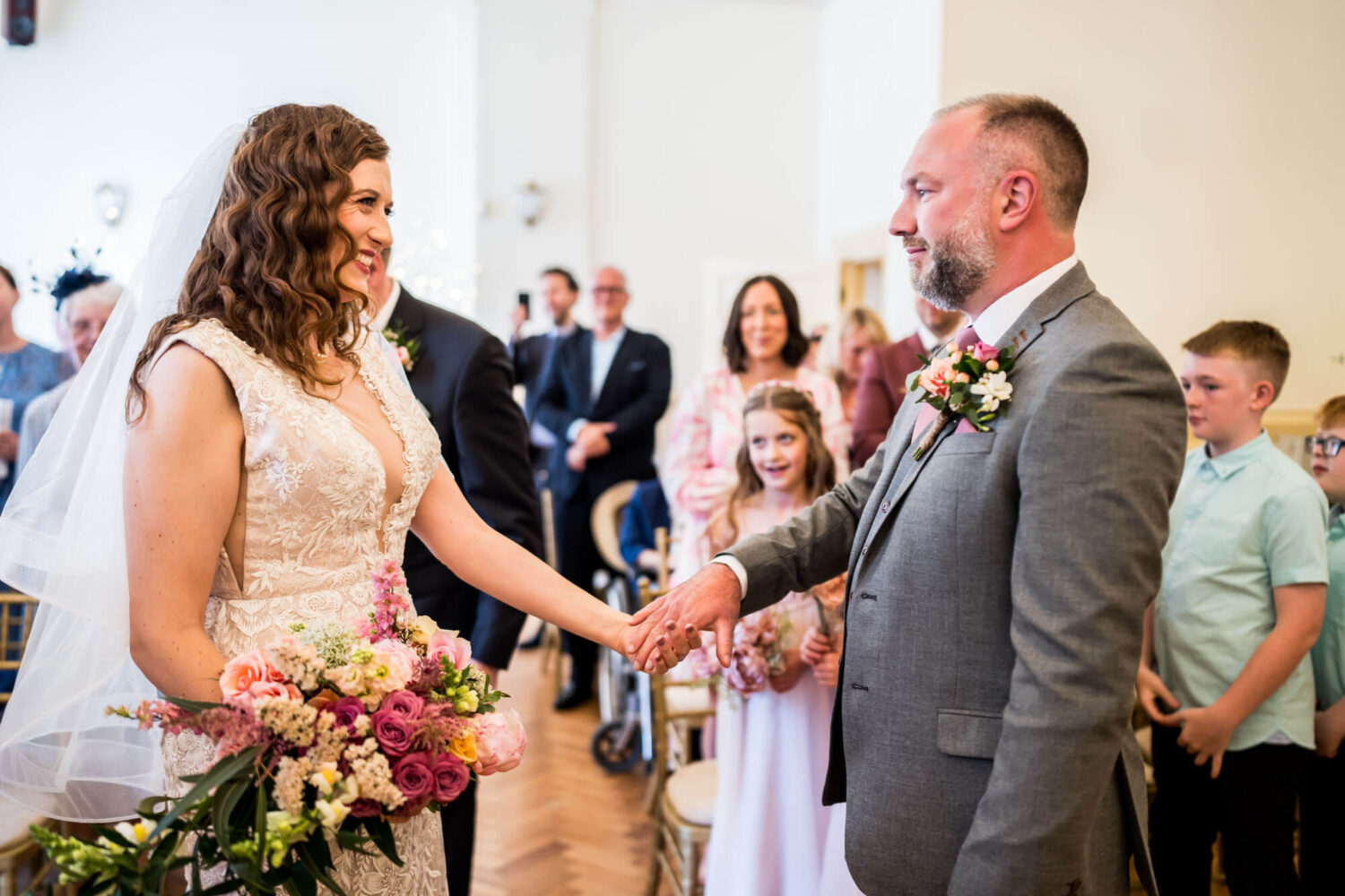 bride and groom holding hands after seeing each other for the first time