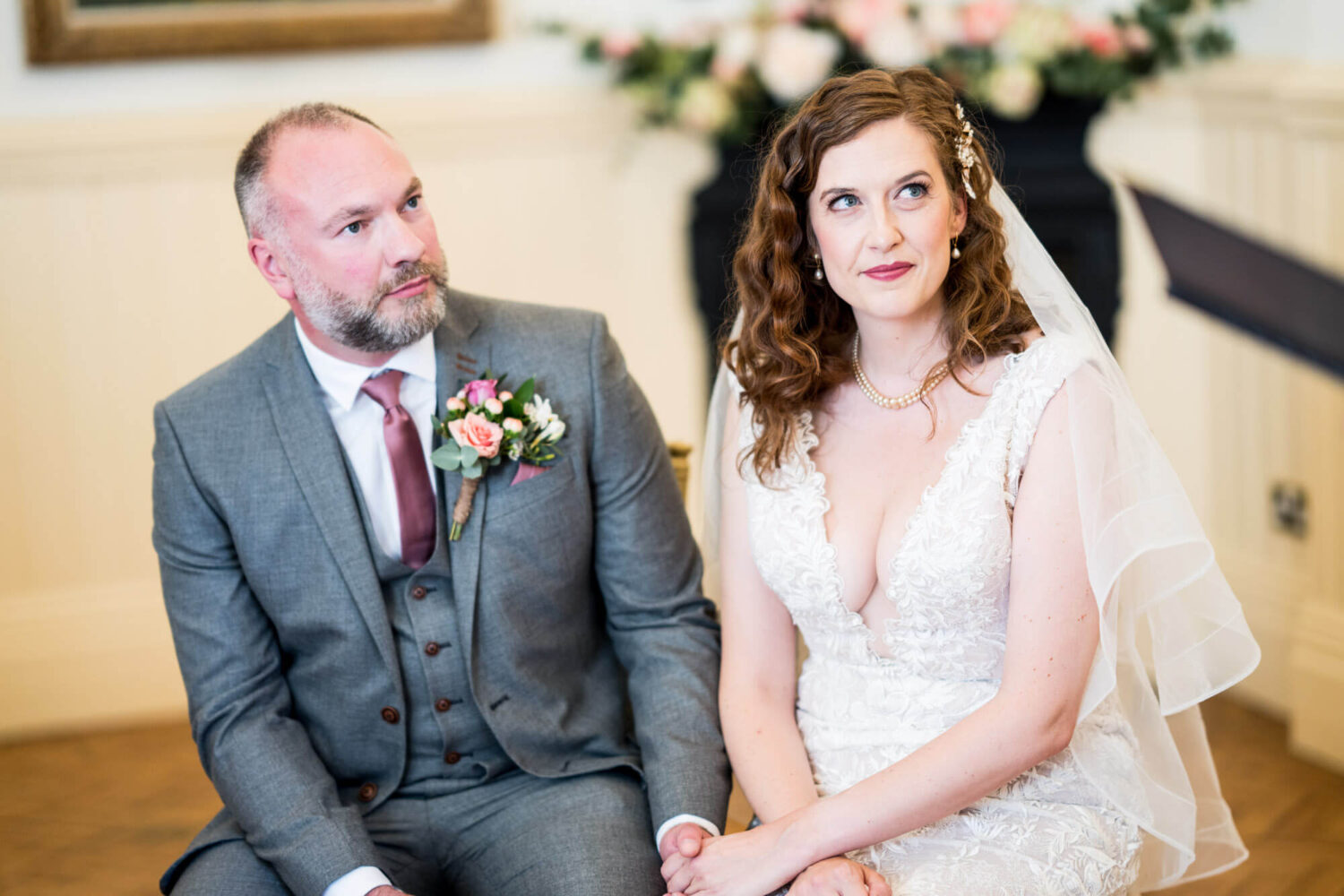 bride and groom sitting listening to registrar brighton wedding