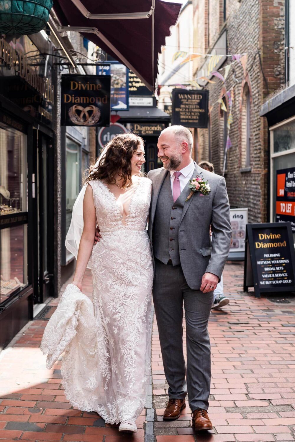 bride and groom walking through south lanes smiling